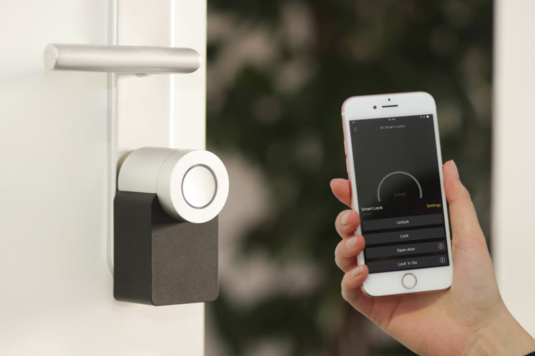 gold Apple iPhone smartphone held at the door on Affordable Smart Living
