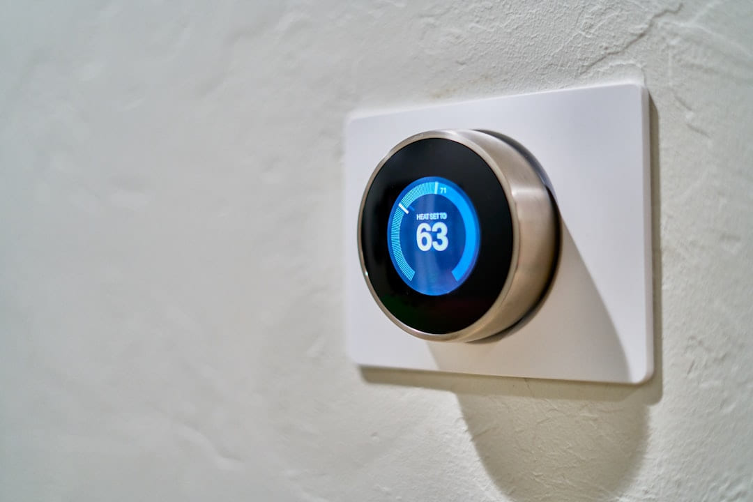 gray Nest thermostat displaying at 63 on Affordable Smart Living