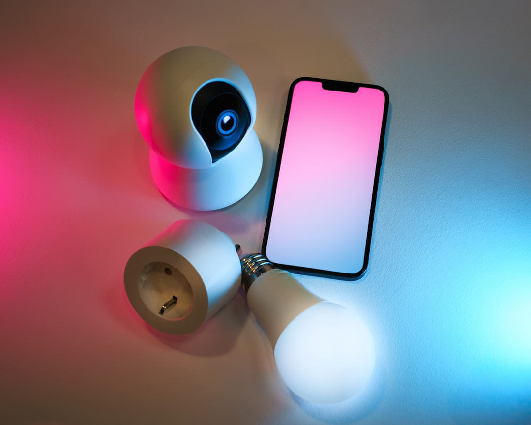 A smart phone sitting on top of a table next to a flashlight on Affordable Smart Living