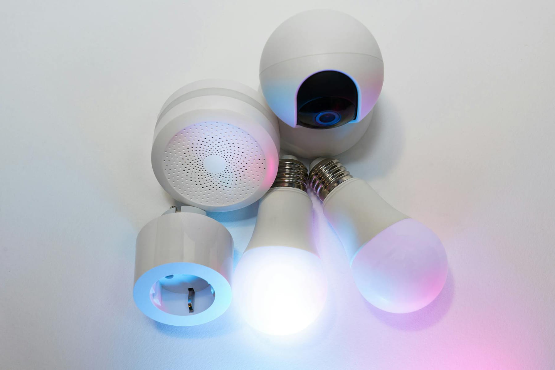 A collection of smart home devices including light bulbs, a security camera, and a smart hub. on Affordable Smart Living