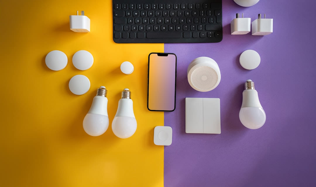a computer keyboard, light bulbs, and other electronics on a purple and yellow background on Affordable Smart Living