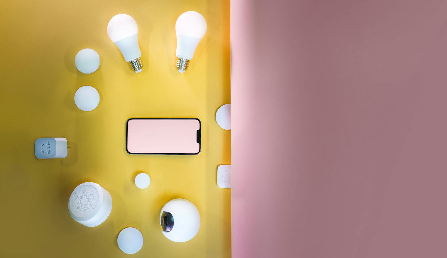 Flat lay of smart home devices with vibrant pink and yellow gradient background. on Affordable Smart Living