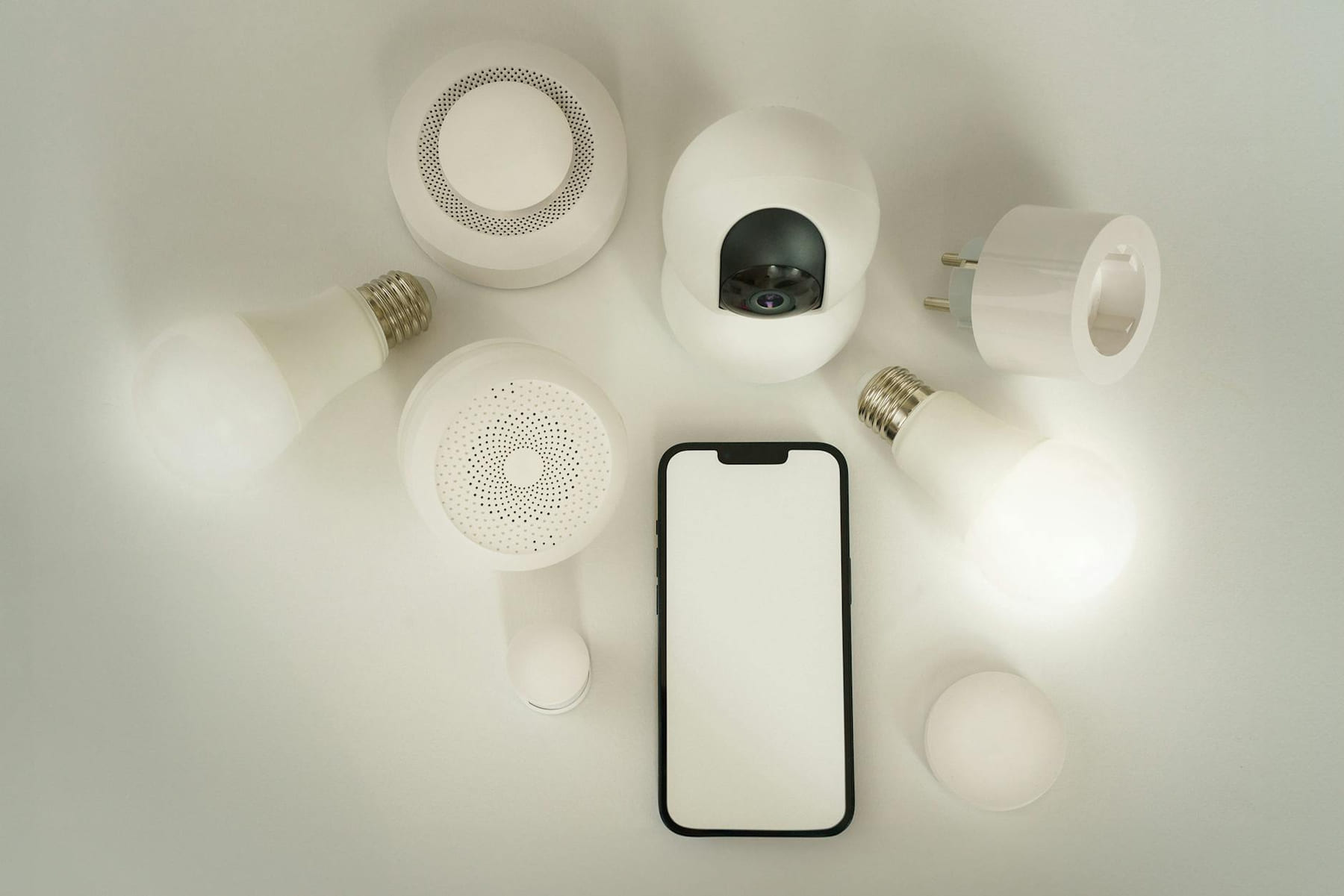 Flat lay of smart home devices with a smartphone controller on a white background. on Affordable Smart Living