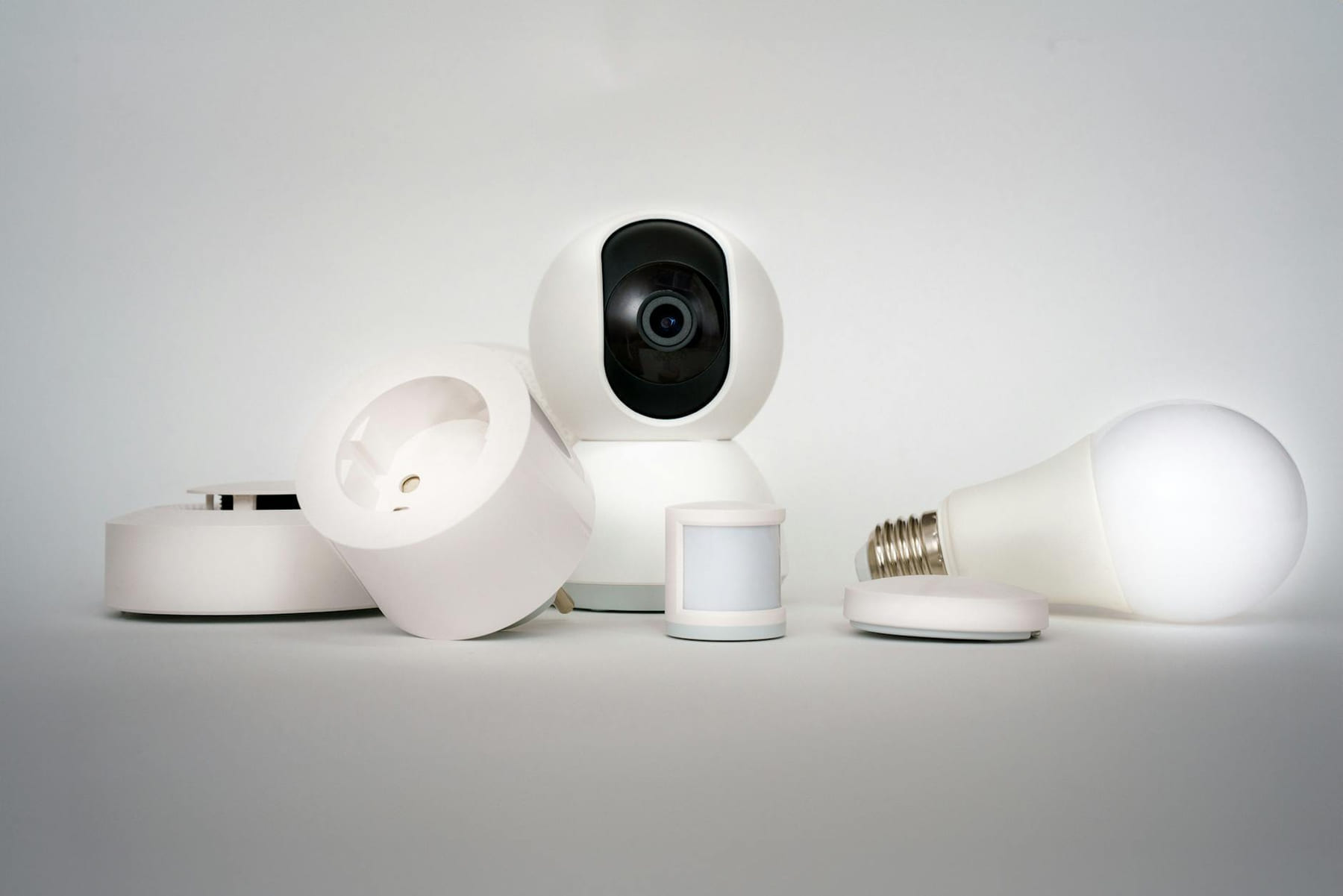 A range of smart home devices including camera and lightbulb in a minimalist setup. on Affordable Smart Living