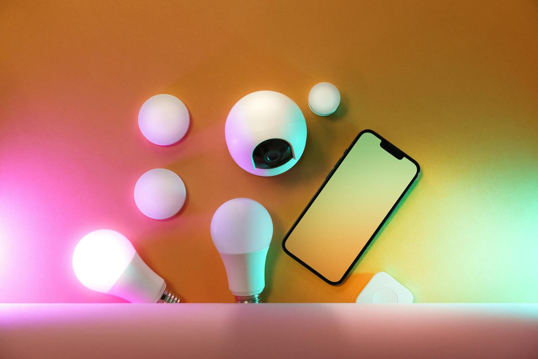 A collection of smart home devices including light bulbs and a smartphone, showcasing modern technology. on Affordable Smart Living