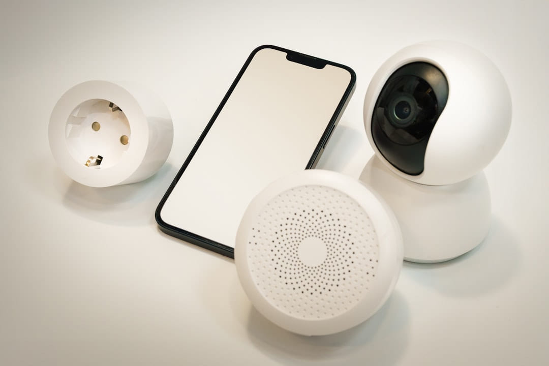 A cell phone and a camera sitting on a table on Affordable Smart Living